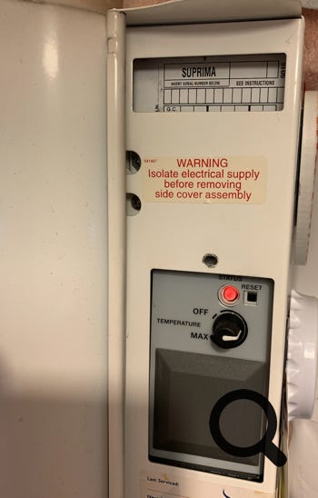 Photo of Suprima data label showing red LED fault code and blank spaces where data should have been entered by person replacing the PCB.